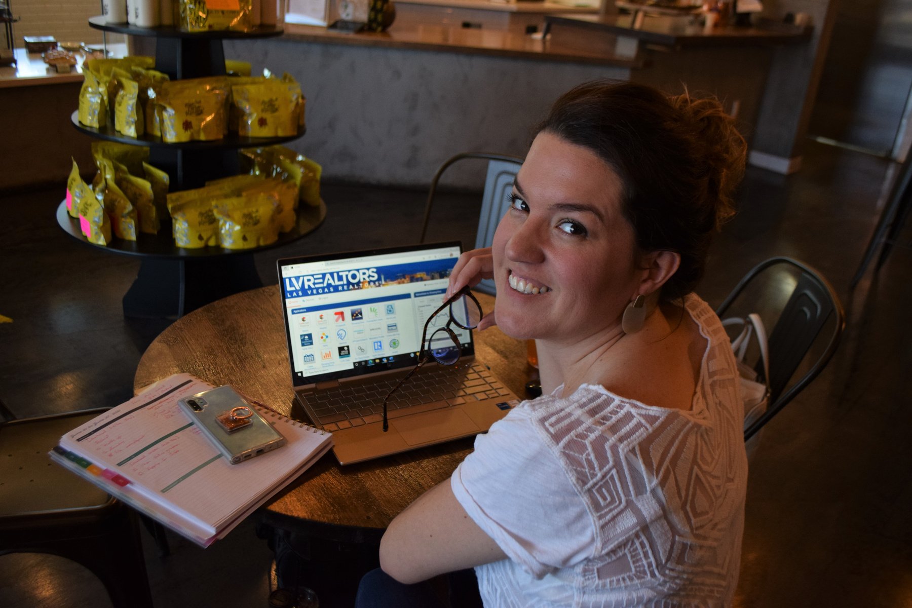 Susie Homemaker LV sitting at a table with a laptop in front of her