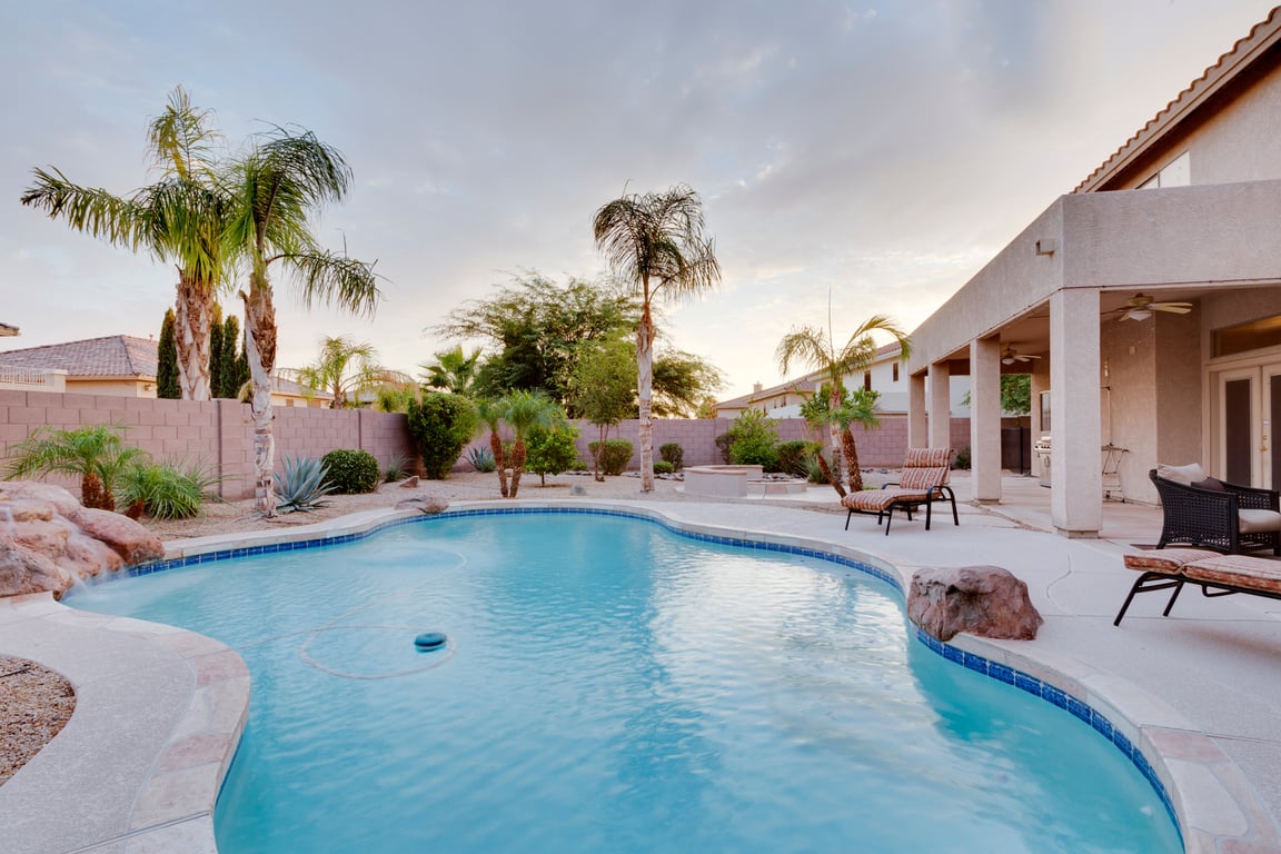 A backyard with pool at a desert home