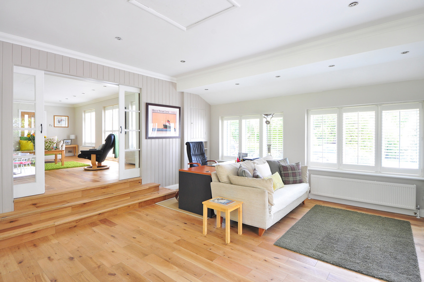 a living room with wooden floors and white walls link for buyer recourses page.